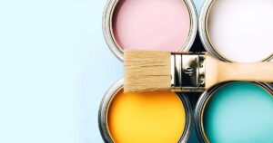 four paint pots and a paint brush