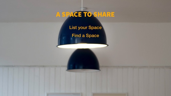 dark blue light shades hang from a white ceiling in a white room