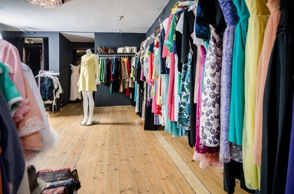 rows of dresses hanging on hangers in a vintage dress shop called Those Were The Days