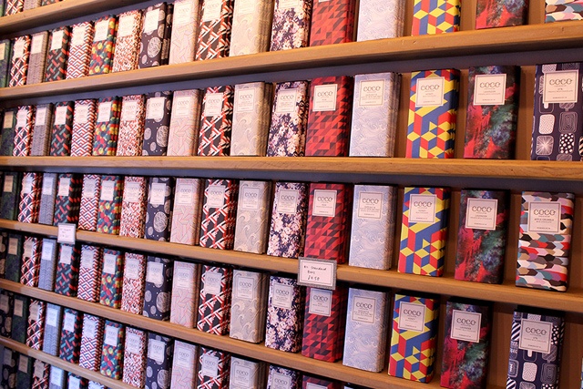 bars of luxury chocolate line the shelves of a shop