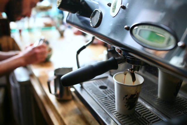 a coffee making machine on a wooden counter