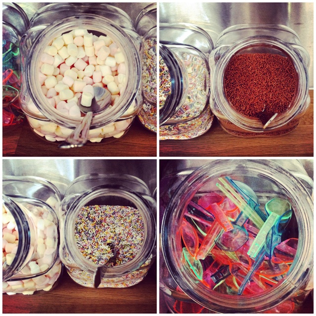 four images of large clear jars containing different sprinkles for ice cream