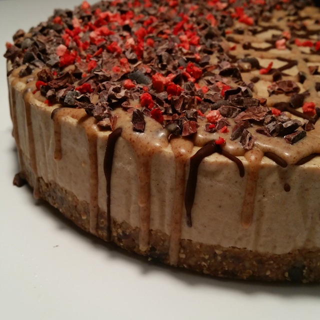 a round caramel strawberry and chocolate cheesecake