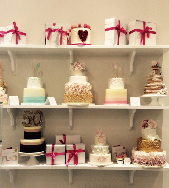 rows of cakes on three shelves