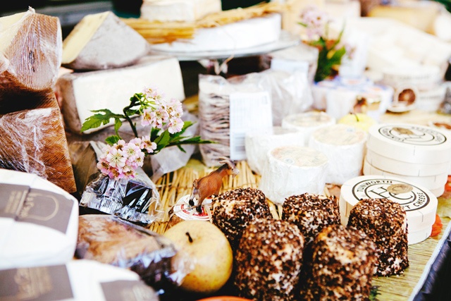 a large selection of cheeses on a table