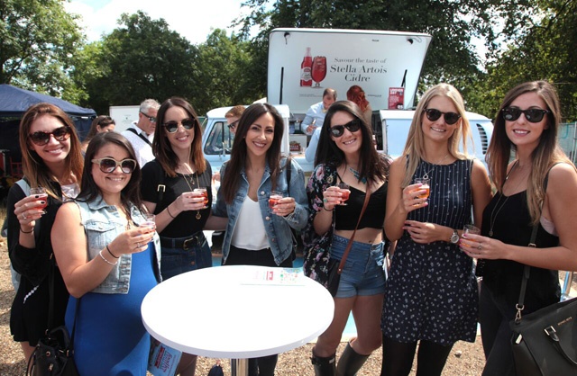 girls enjoying drinks at a food festival