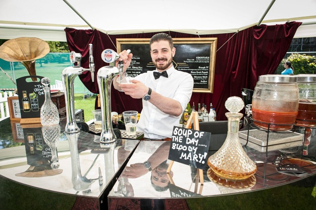 a barman at a cocktail bar at a food festival