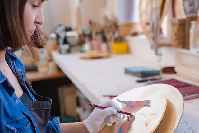 a female artist sits painting