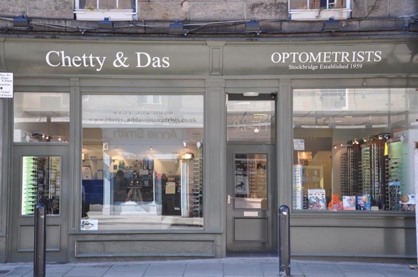 olive green shop front of Chetty and Das with doorway between two large windows