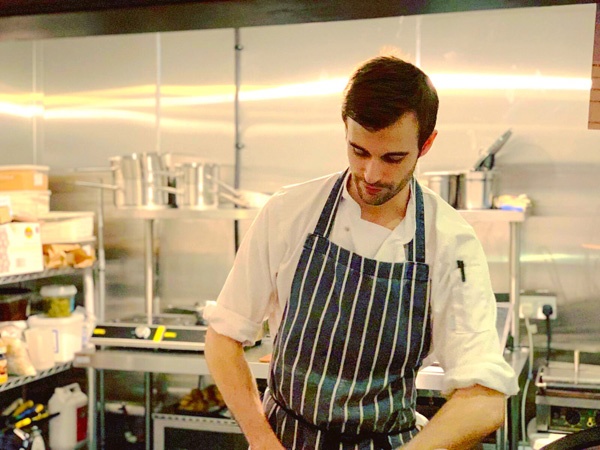 male chef prepares food in a restaurant kitchen