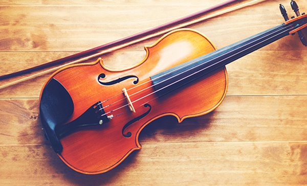 violin and bow on a wooden floor