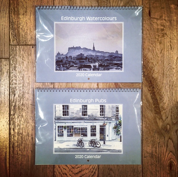 two calendars on a wooden floor