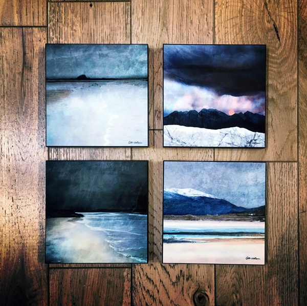 landscape scenes painted on ceramic tiles lying on a wooden floor