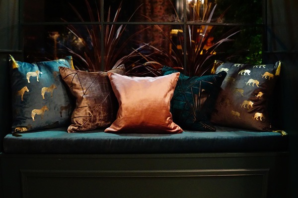 five silk fabric cushions on a seat