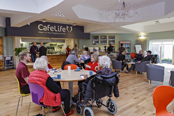 people sit eating and drinking in CafeLife