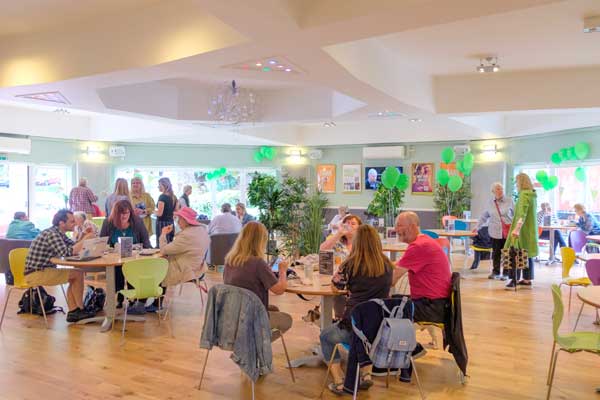 Opening Day at a crowded cafe officially opened by Val McDermid