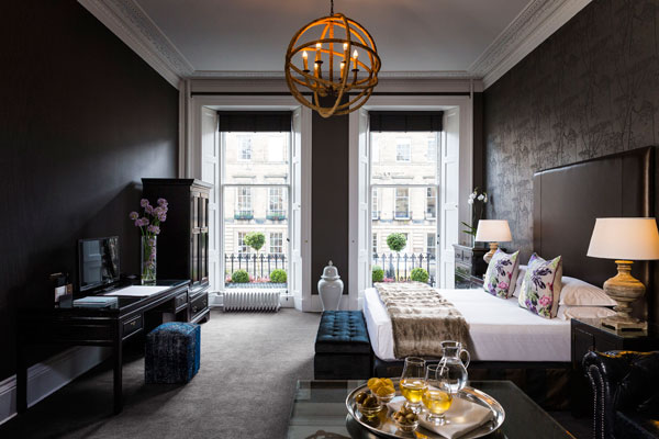 A stunning Georgian bedroom suite with double floor to ceiling windows in the Nira Caledonia Hotel in Edinburgh Scotland
